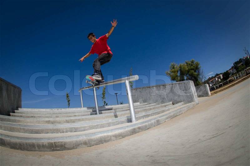 Skateboarder on a slide, stock photo
