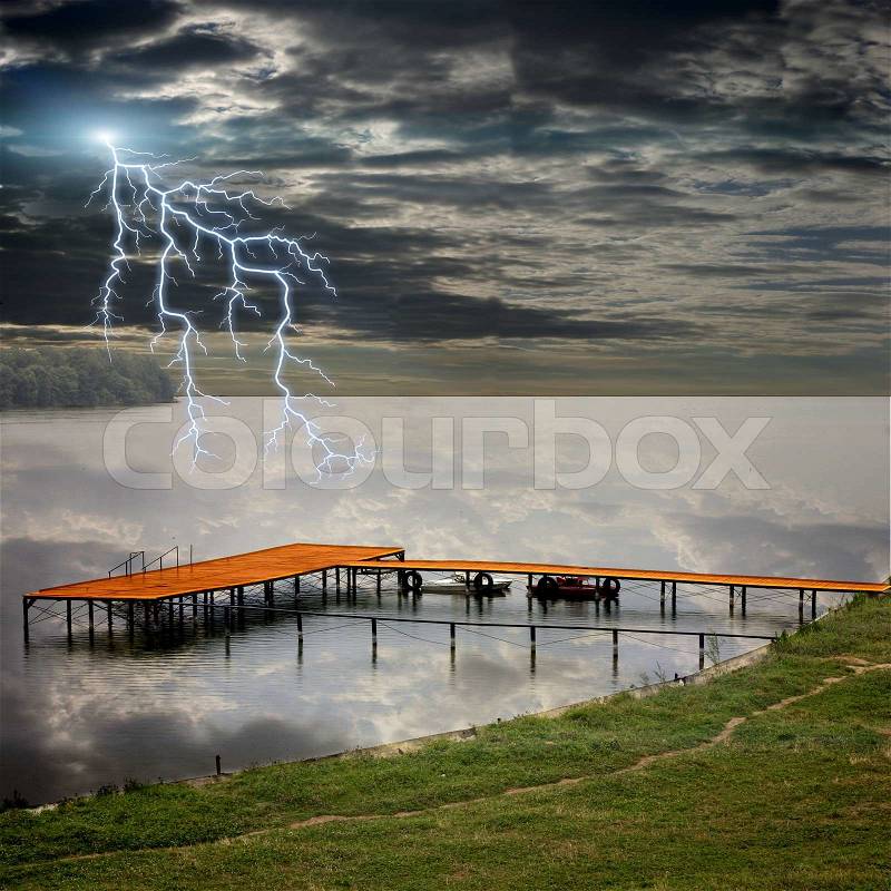 Boat station on the beautiful lake and storm lightnings, stock photo
