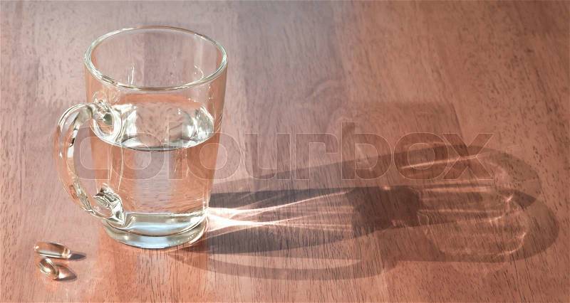 Cup of water with pills, stock photo