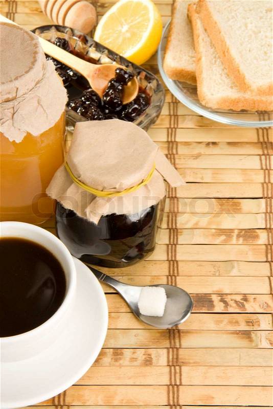 Coffee, honey and bread on table, stock photo
