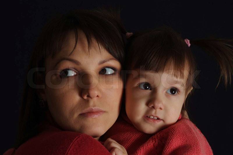 Nice sad Caucasian woman with a daughter, stock photo