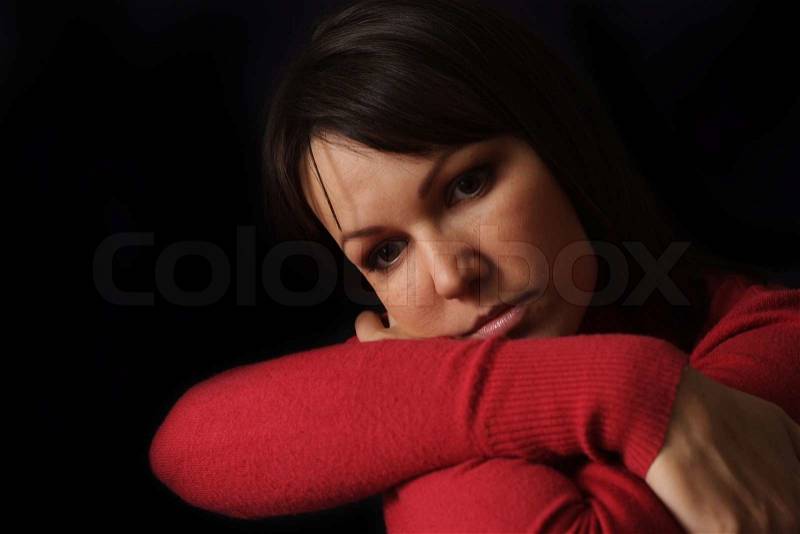Happy sad Caucasian female sitting, stock photo