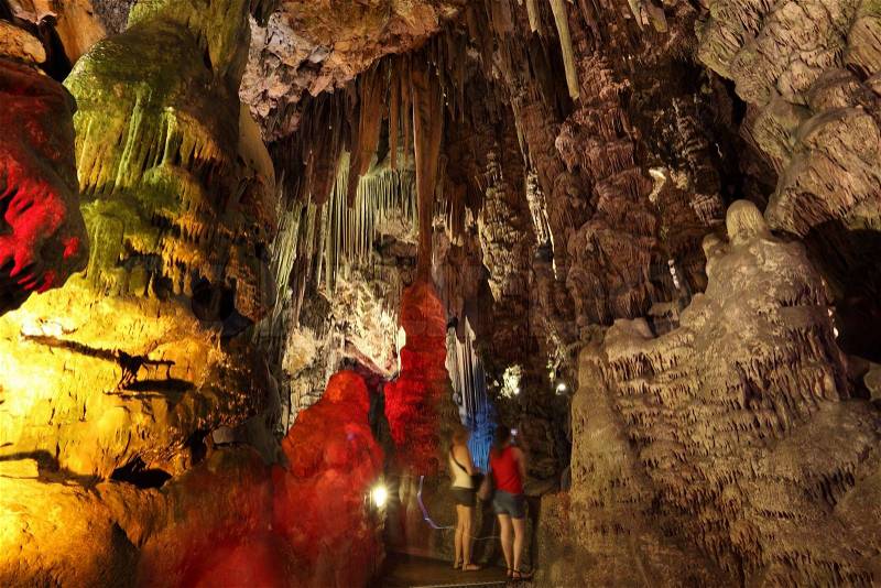 Illuminated stalactites inside of the St Michaels Cave of Gibraltar, stock photo