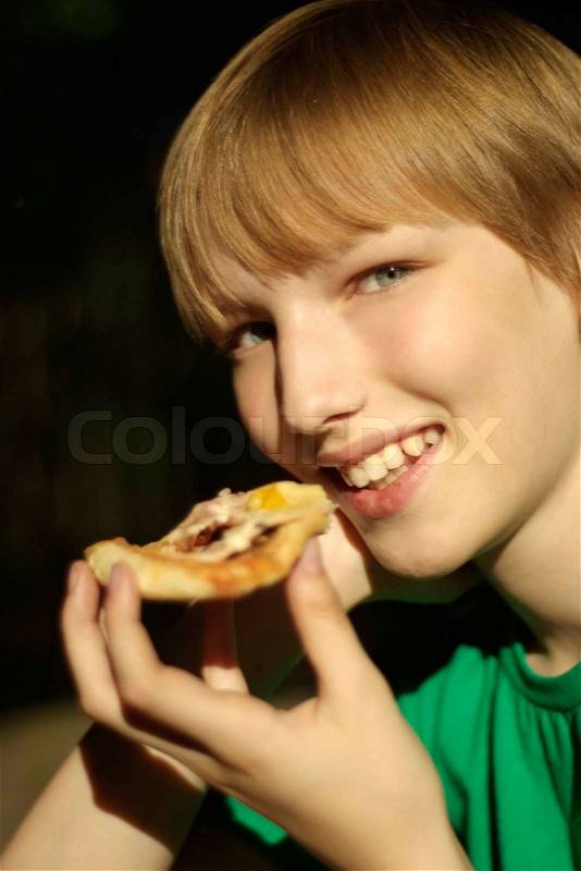 Boy like to eat pizza, stock photo