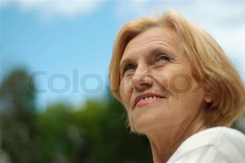 Lovely elderlywoman went on the nature, stock photo