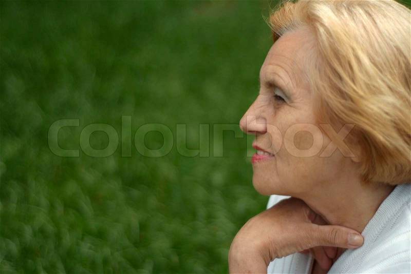 Pretty elderlywoman went on the nature, stock photo