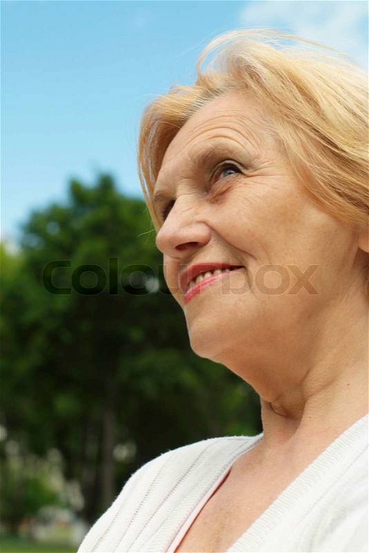 Nice elderlywoman went on the nature, stock photo