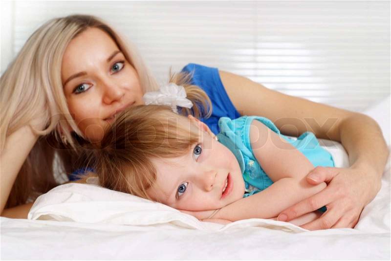 Nice caucasian mother and daughter lying, stock photo