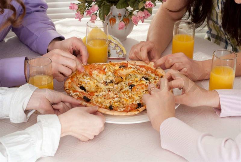 Young people eat the pizza, stock photo