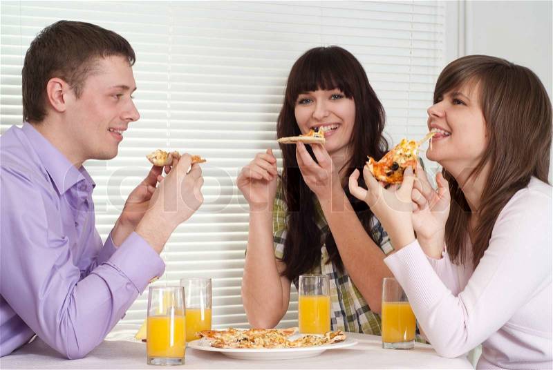 Joking people eat the pizza, stock photo