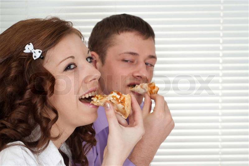 Lovely people eat the pizza, stock photo