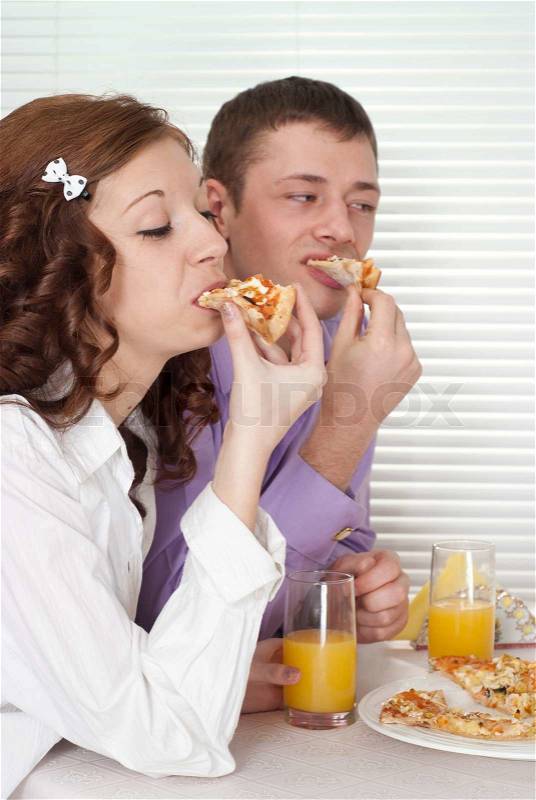 Fine people eat the pizza, stock photo