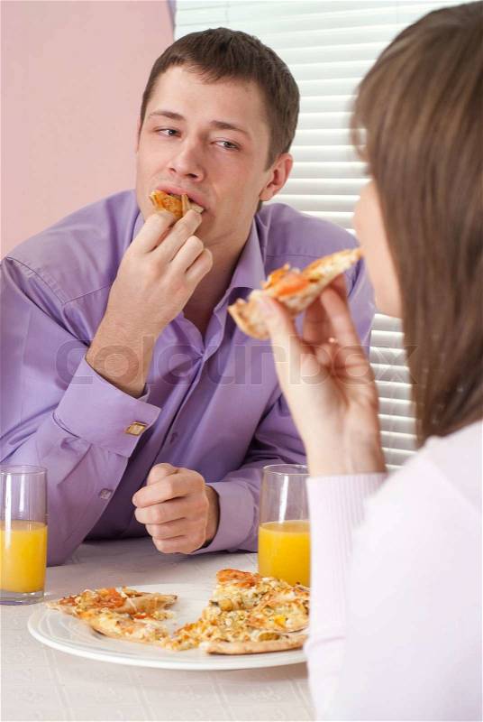 Glad people eat the pizza, stock photo
