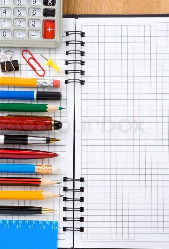 Back to school concept and checked notebook on wood background, stock photo