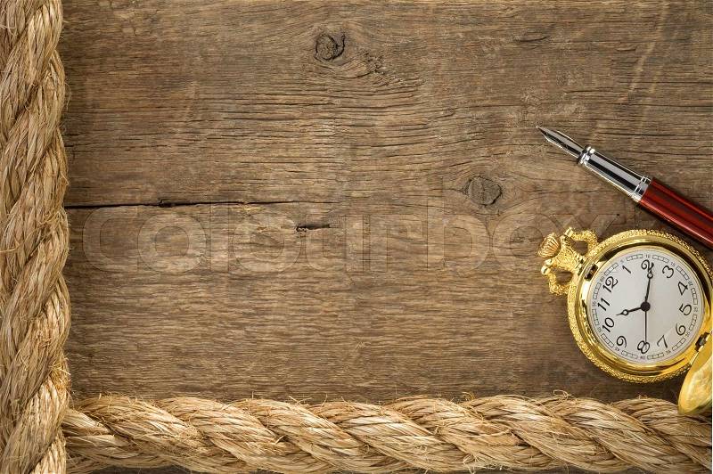 Ship ropes and watch with ink pen on old wood, stock photo