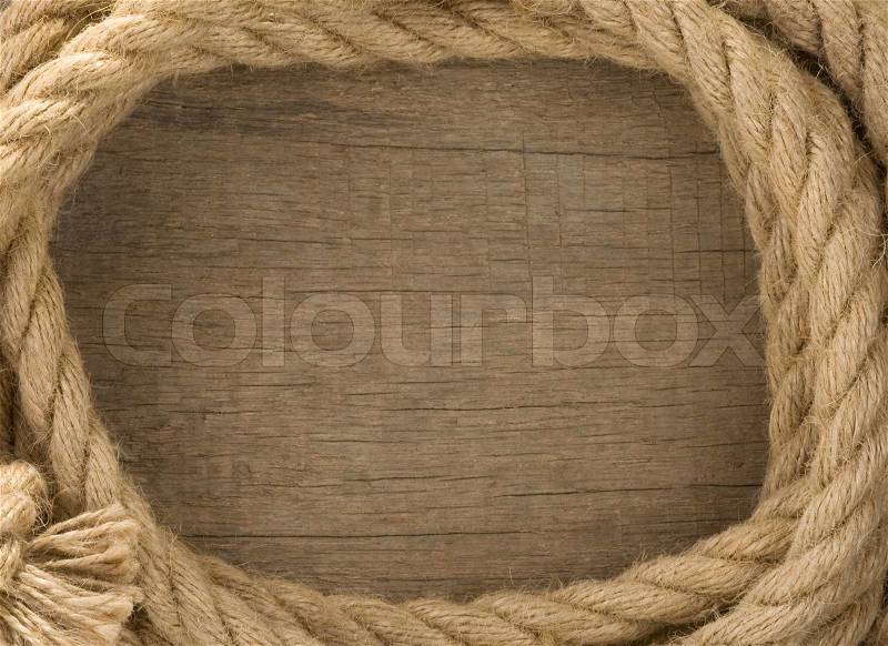 Ship ropes and knot on wood background, stock photo