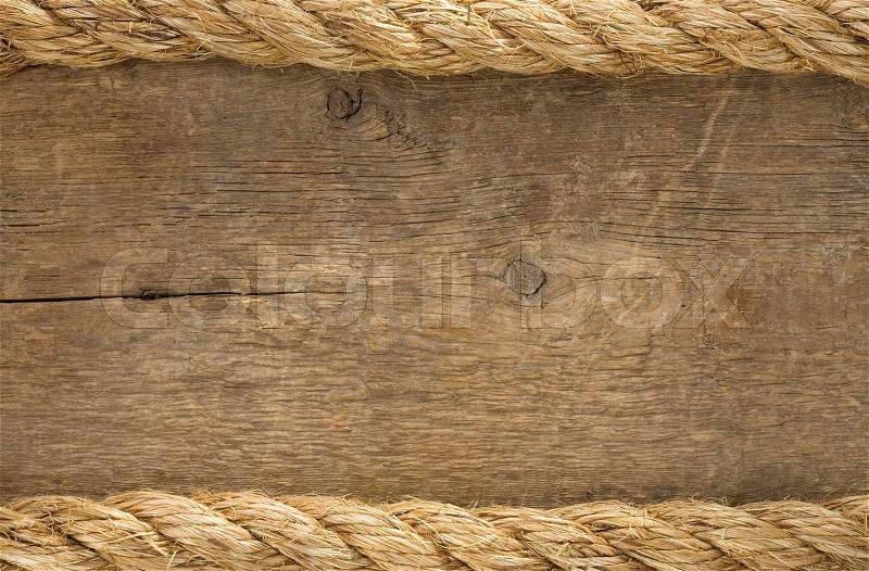 Ship ropes borders on wood background, stock photo