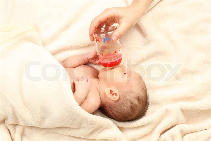 Mother bottle-feed her little baby, stock photo