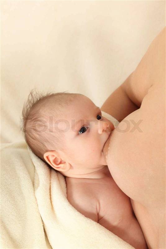 Mother breastfeeding her newborn baby, stock photo