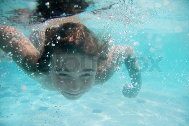 Young child girl underwater, stock photo
