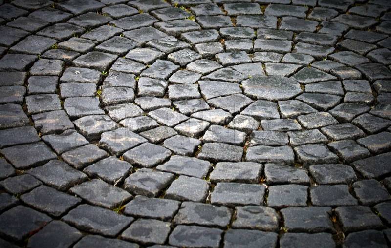 Background texture of round cobblestone pavement square, stock photo