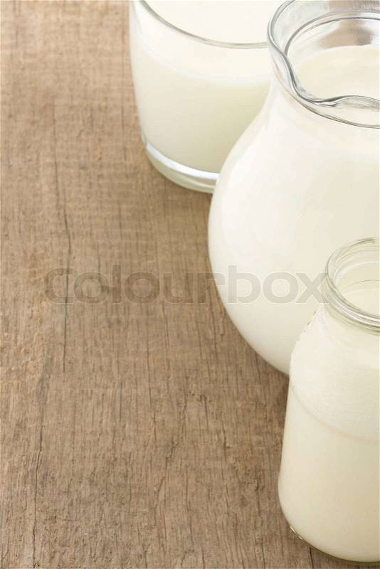 Milk in glass and battle on wood, stock photo