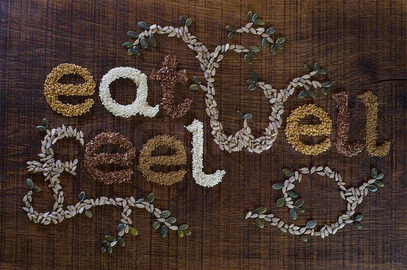 The phrase \'Eat Well, Be Well\', written and decorated in seeds, stock photo