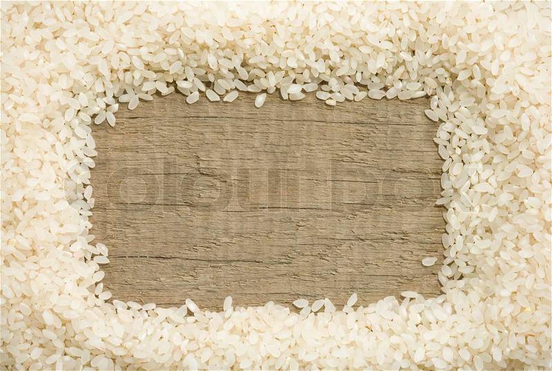 Rice grain on wood background, stock photo