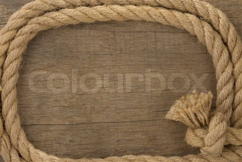 Ship ropes borders on wood background, stock photo