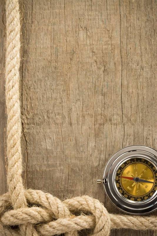 Ship ropes and compass on wood, stock photo