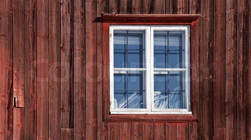 Texture of a window on the old red wooden wall Traditional Scandinavian house, stock photo
