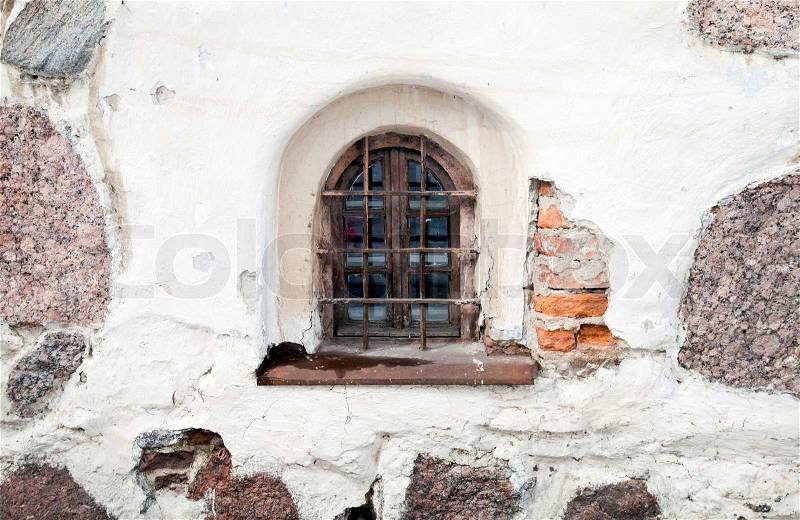 Background texture of old white stone wall with window, stock photo