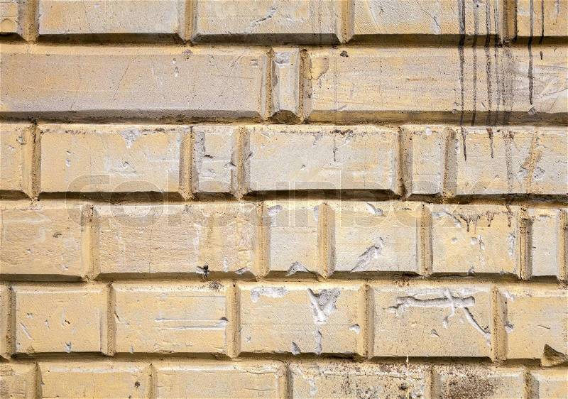 Background texture of old yellow painted concrete wall with decorative elements, stock photo