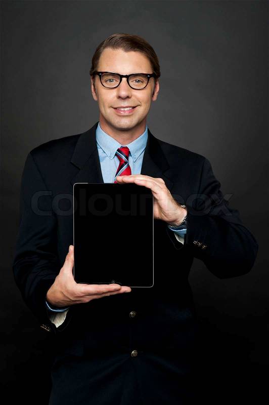 Portrait of businessman showing new digital device, stock photo