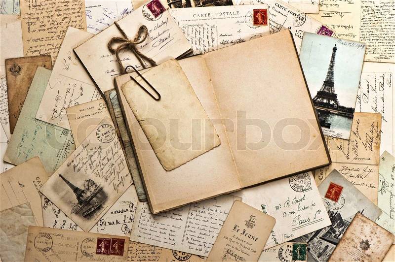Old papers, french post cards and open diary book, stock photo