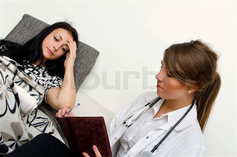 Female doctor visiting patient at home, stock photo