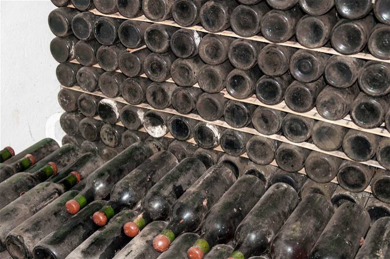 Wine bottles stored in the old wine cellar, stock photo
