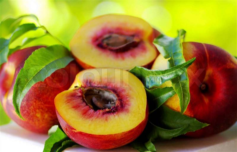 Sliced peachs on green background, stock photo