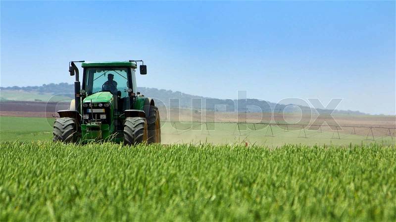 Green tractor working, stock photo