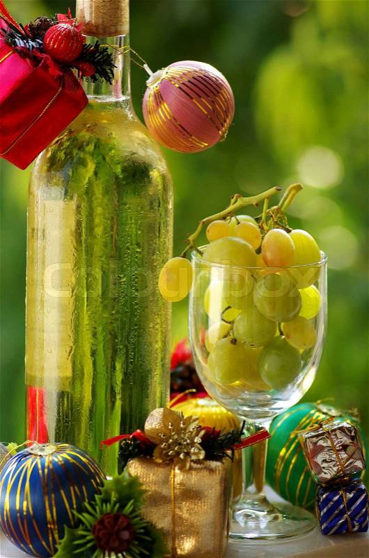 Decorated bottle of white wine with Christmas presents, stock photo