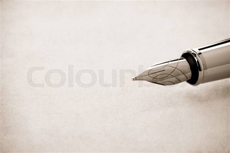 Ink pen and parchment background, stock photo