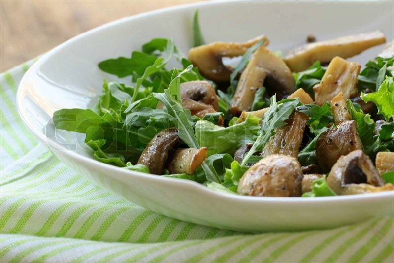 Fresh salad with arugula , grilled mushrooms, stock photo