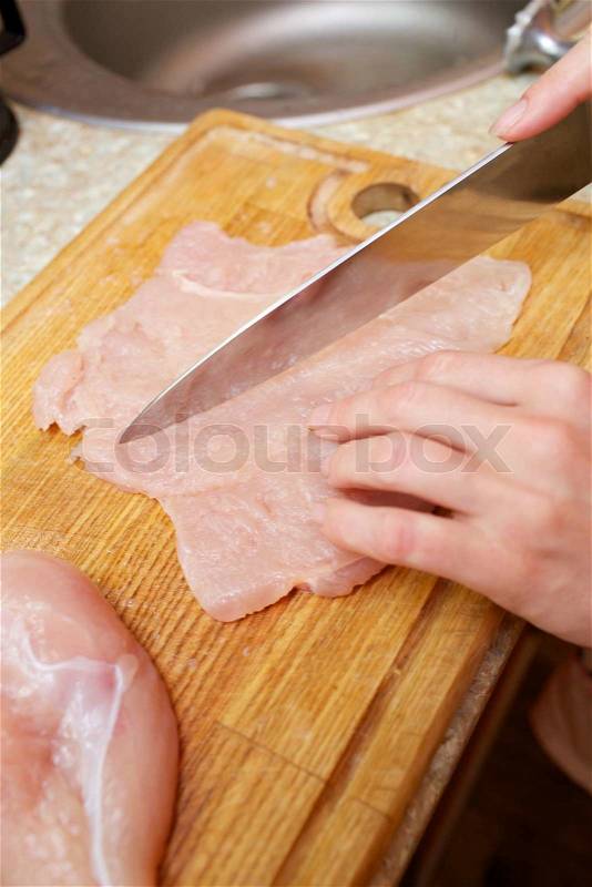 Cutting chicken meat, stock photo