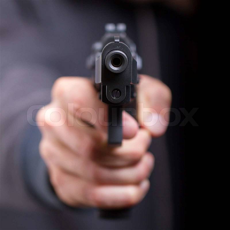 Man with gun, gangster, focus on the gun, stock photo