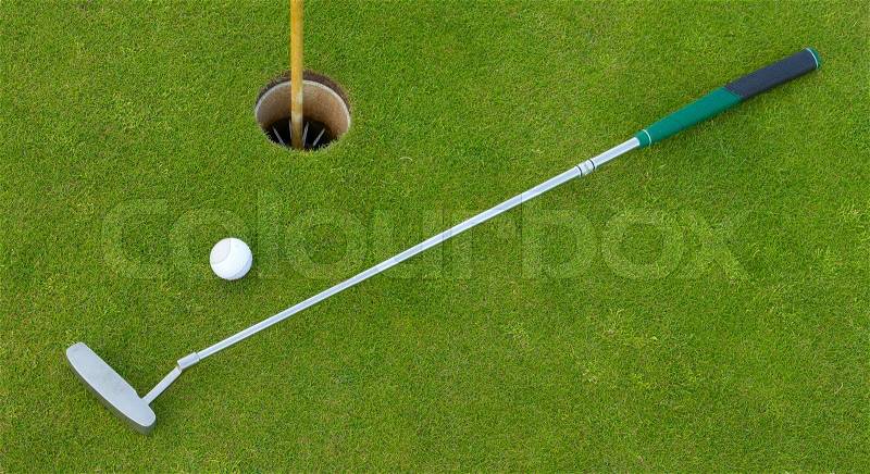 Golf hole with ball and putt, stock photo