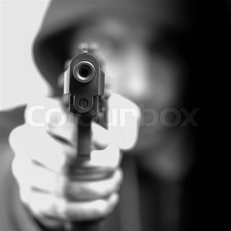 Man with gun, gangster, focus on the gun, stock photo