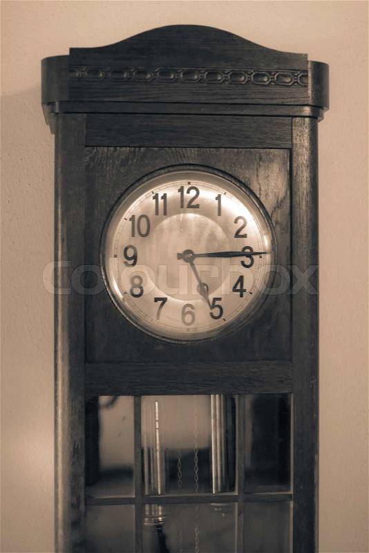 Antique clock in sepia color, stock photo