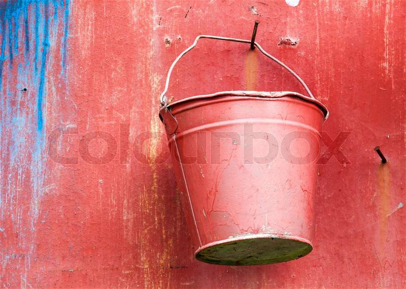 Fire fighting equipment, red metal bucket on the wall, stock photo