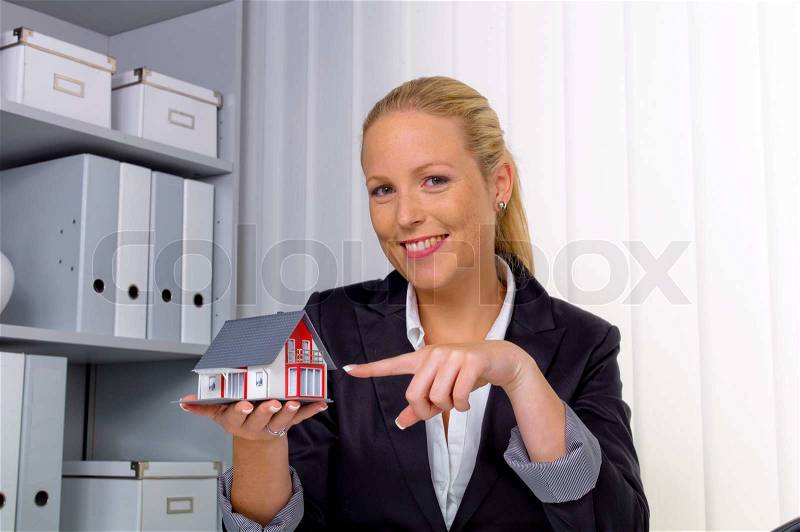 Real estate agent in her office, stock photo