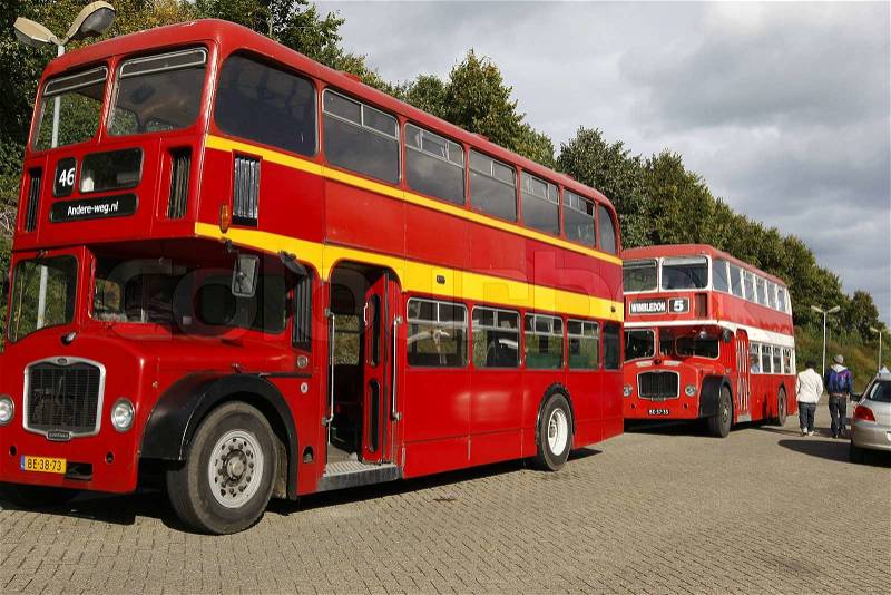 Two old red double decker buses, stock photo